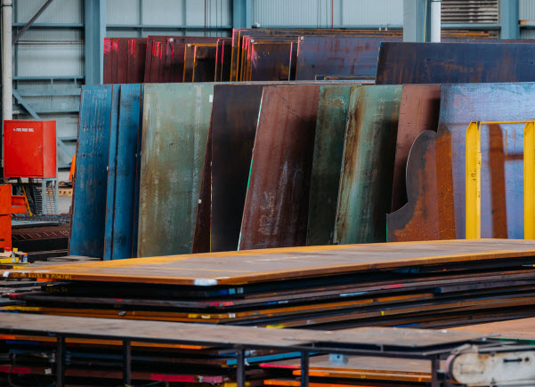 Stock of Steel plates placed inside the warehouse