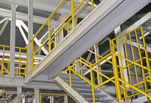 Industrial stairs with yellow handrails